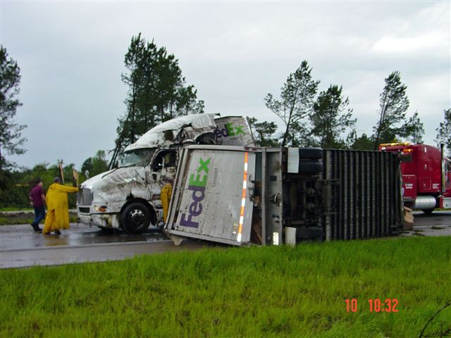 Semi-Trucks blown over and into each other on the road.